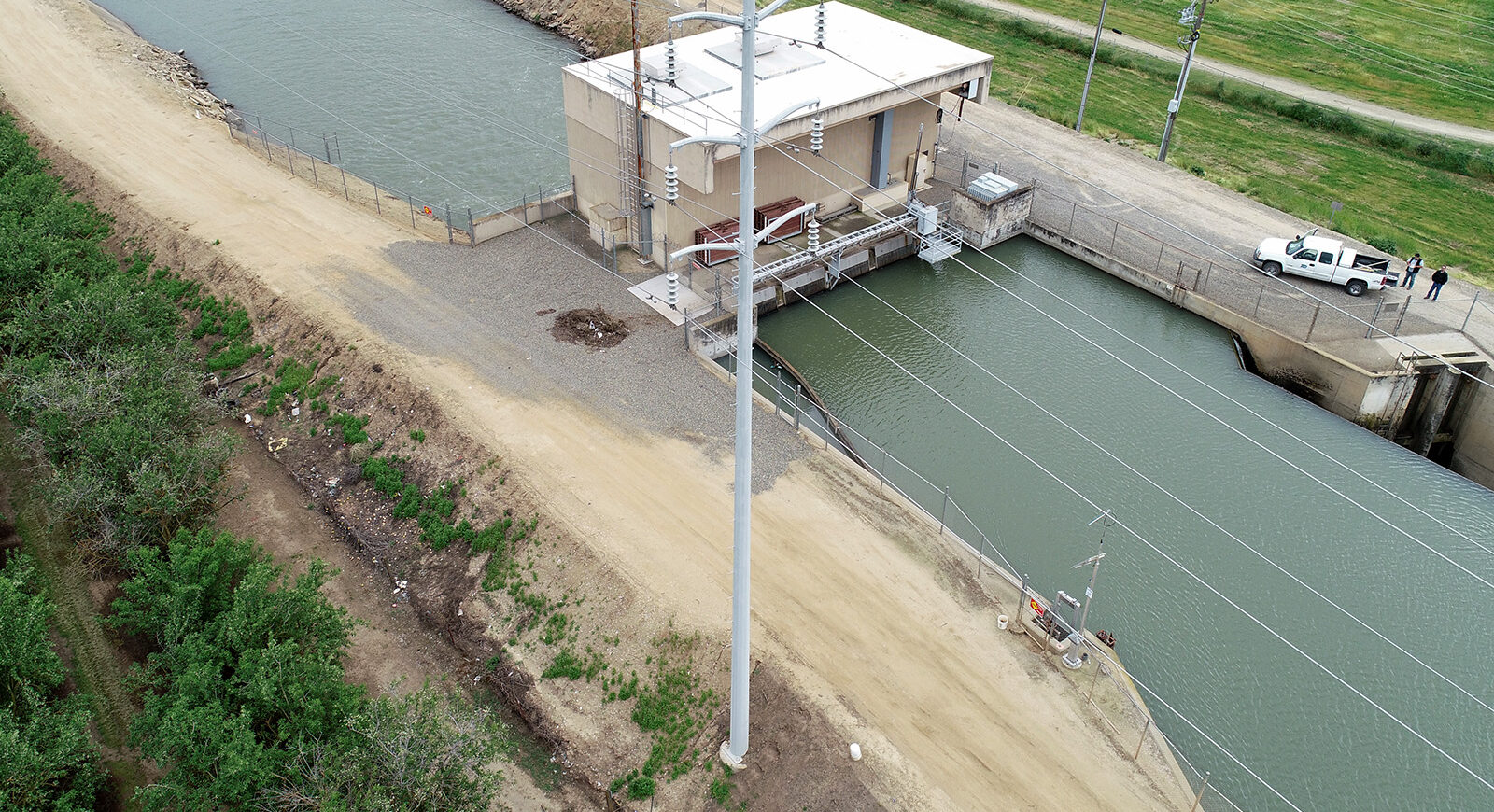 Aerial shot of small hydroelectric station over a canal