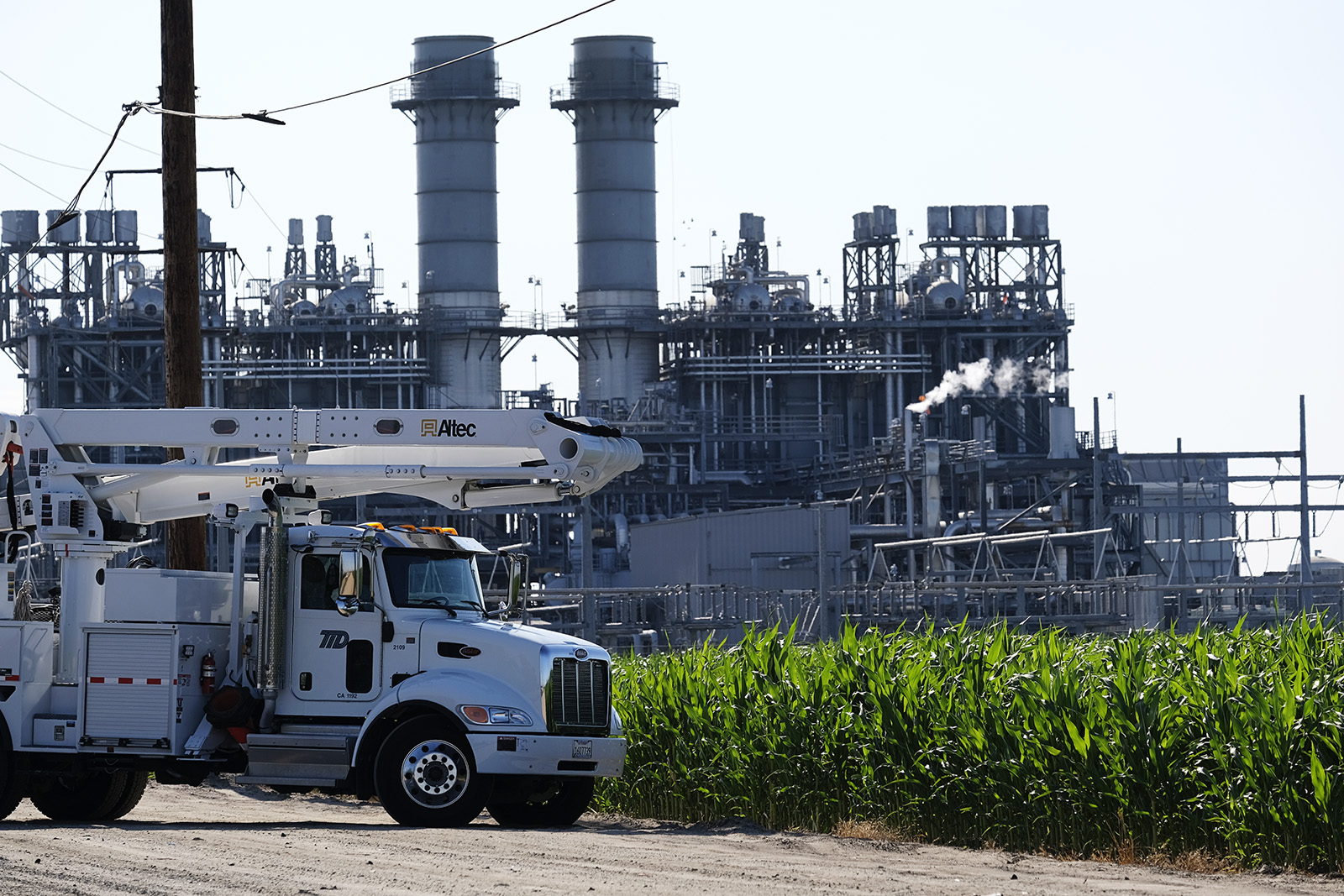Walnut energy center with line truck out in front and corn field in front