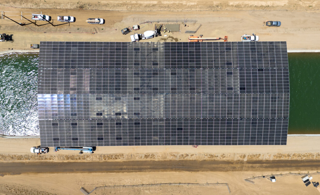 Top-down view of solar canopy structure over large irrigation canal.
