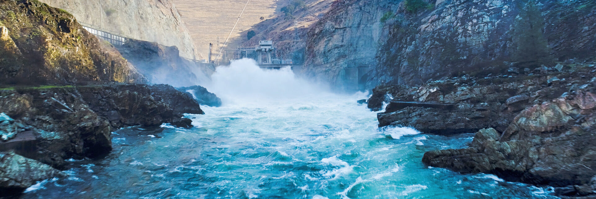 Water level view of water coursing out of power facility