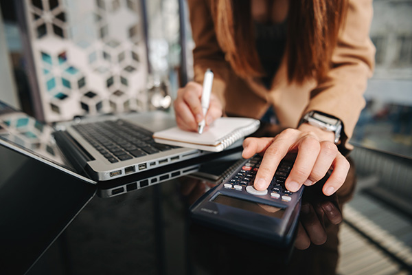 womans hand on a calculator